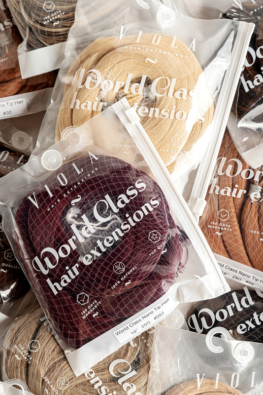 Packaged hair extensions with 'World Class' branding on clear plastic packaging.